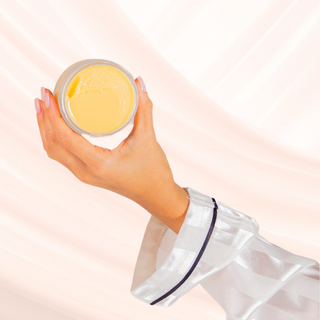 hand holding opened BIOMAZE Gentle Microdermabrasion Balm to Milk Cleanser and gentle exfoliant