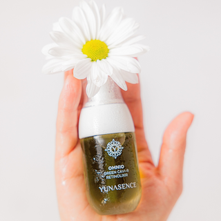 OMNIO Green Cavi-R Retinolixir, Bio-Retinol Liquid Lift placed in human hand