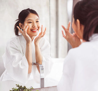 woman looking at herself in the mirror