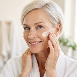 woman applying skin care to her face