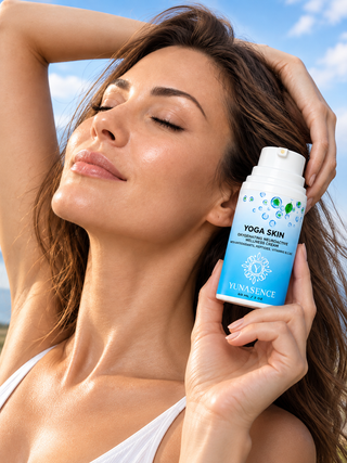 A woman outdoors holding a blue and white YUNASENCE Yoga Skin  bottle next to her face, with a blue sky background.
