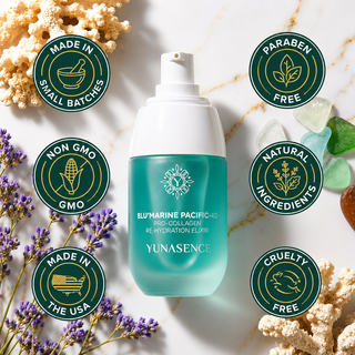 A bottle of YUNASENCE Blumarine Pacific-40 Pro-Collagen Rehydration Elixir centered on a white marble background, surrounded by decorative coral, purple flowers, and circular badges reading Made in Small Batches, Non GMO, Natural Ingredients, Cruelty Free, and Paraben Free.