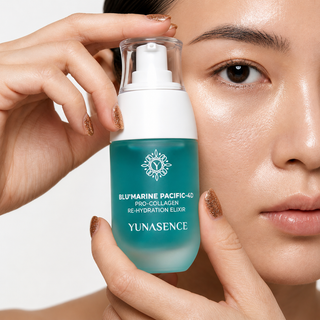 A close-up of a woman holding a bottle of Yunasence Blu'Marine Pacific-4D Pro-Collagen Re-Hydration Elixir, showing the teal and white bottle against her face on a clean white background.