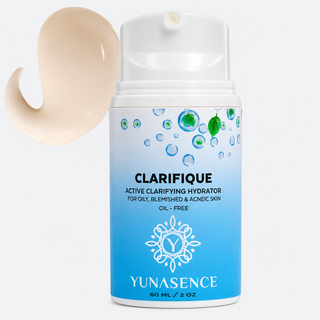 bottle of clarifique hydrator in blue bottle on light gray background with light cream color swatch