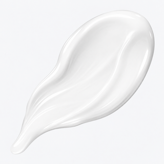 A glossy, thick white cream swatch with smooth, flowing contours on a clean, light gray background.