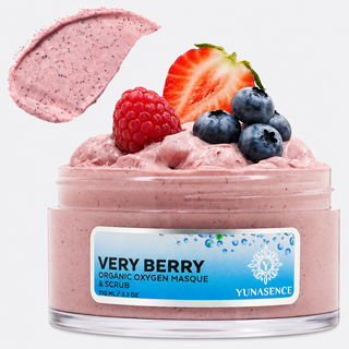 A jar of Yunasence Very Berry Organic Oxygen Masque & Scrub, filled with pink berry-colored cream and topped with fresh berries (raspberry, blueberries, and a strawberry slice), with a matching pink cream swatch shown above the jar on a white background.